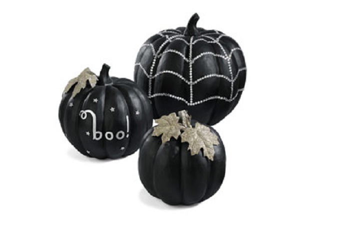 image of black pumpkins decorated for Halloween party.