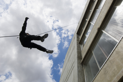 Image of person rappelling down the side of a building