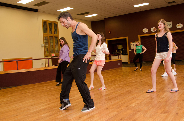 Image of salsa dancer teach a dance class.