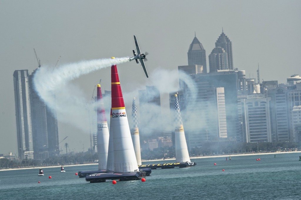 Image of an airplane flying through pylons at a Red Bull Air Race.
