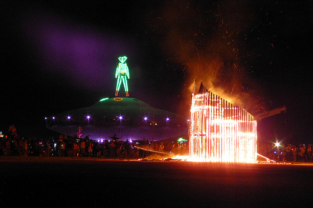 Image of man standing on spaceship at Burning Man Festival in Nevada.