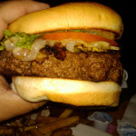 Image of grilled hamburger on a bun.