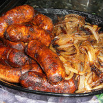 Image of grilled sausages on an outdoor grill.