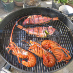 Images of seafood, fish and lobster, cooking on an outdoor grill.