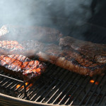 Image of perfecly grilled steak on an outdoor grill.