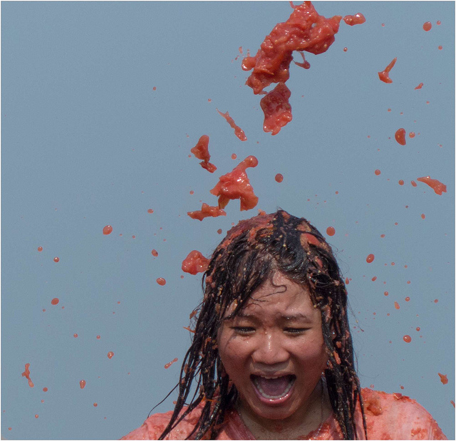 Image of girl being splattered at Tomato Battle